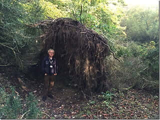 David Jacques next to the Stone Age "eco" home